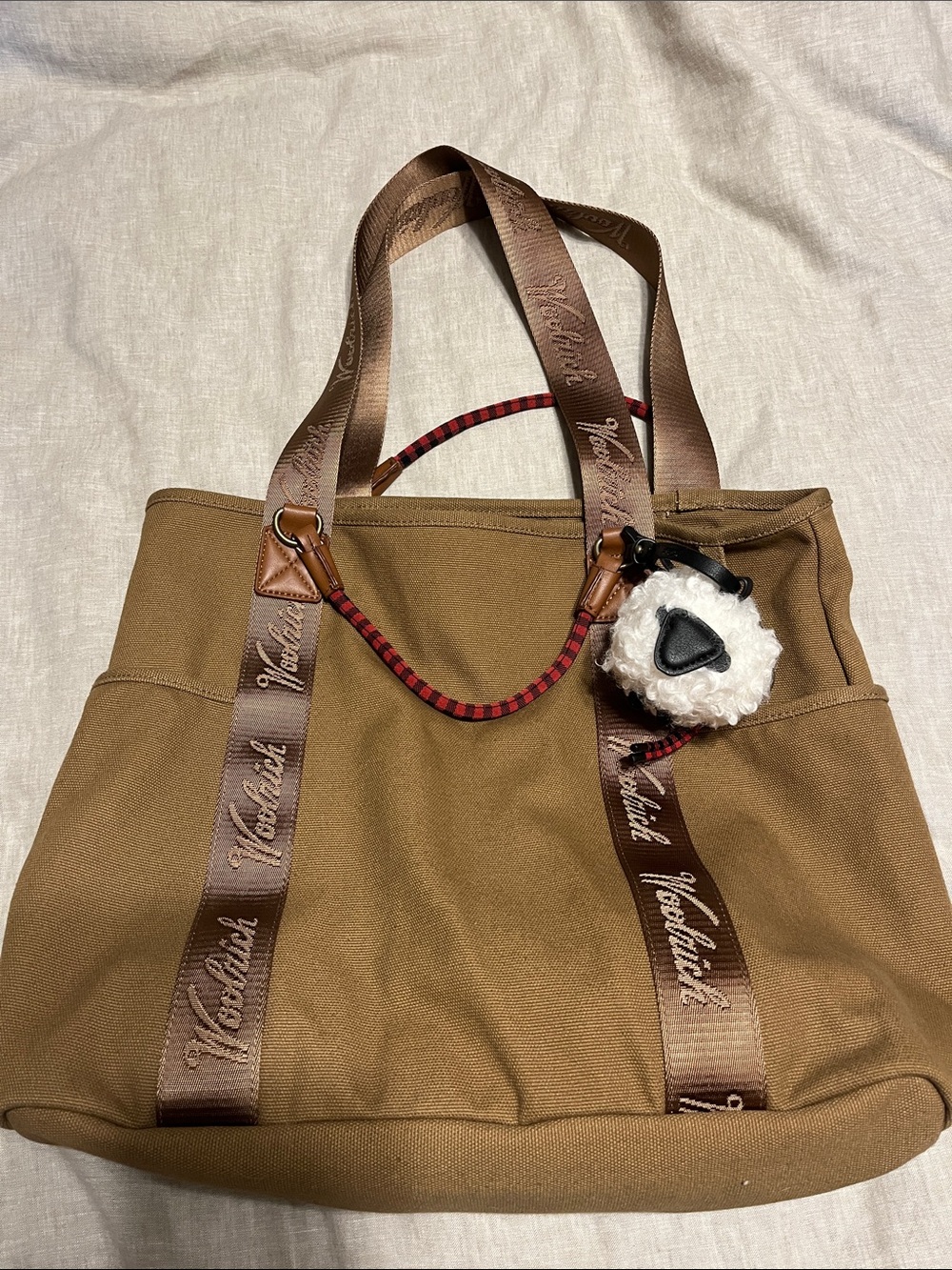 Woolrich Tan Canvas Tote with Branded Brown Straps and White Sheep Pom Charm